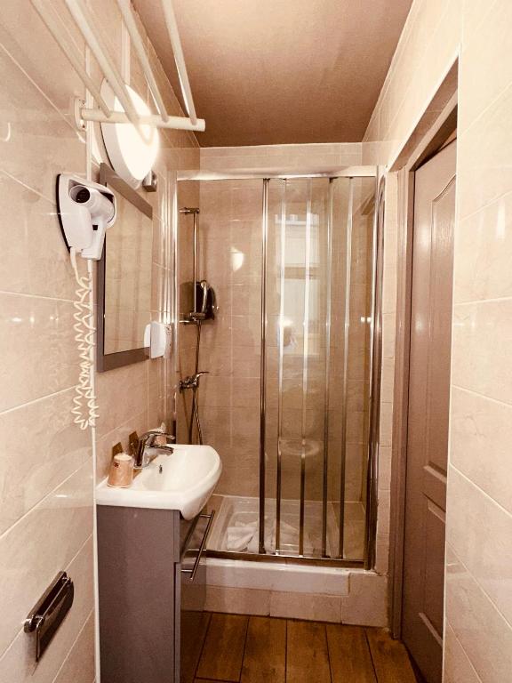 a bathroom with a shower and a sink at Pavillon Opéra Lafayette in Paris
