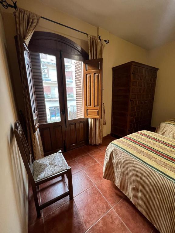 A bed or beds in a room at Apartamentos Turísticos La Posada