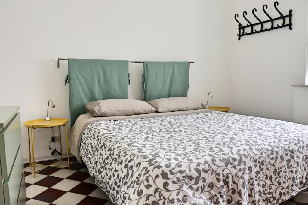 a bedroom with a bed with a black and white comforter at Central Apartment with Panoramic Terrace in Catania