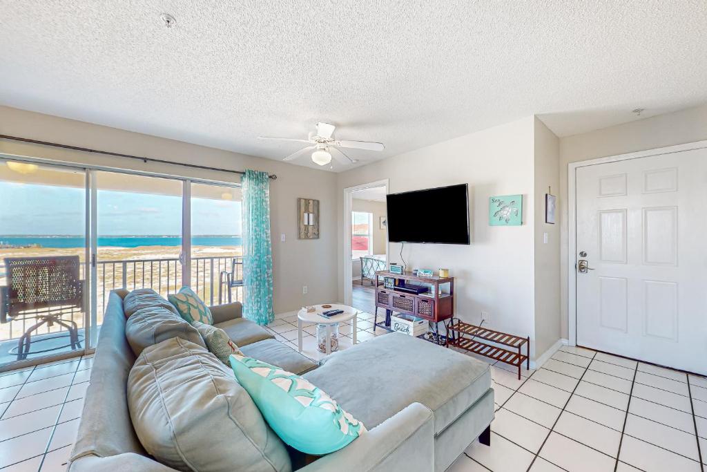 a living room with a couch and a view of the ocean at Sunset Harbor Villas #4-421 in Navarre