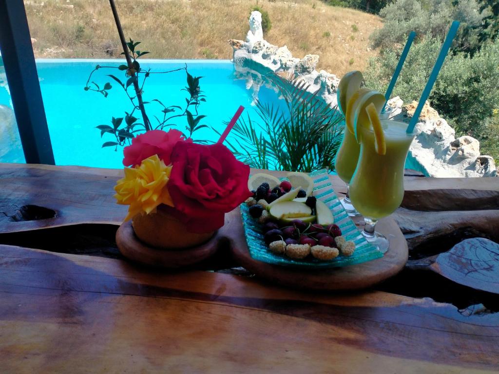 a table with two vases of food and a drink at Villa Mutaf in Kumluca