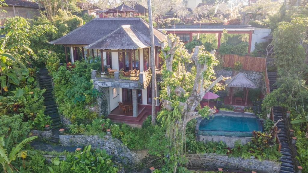 an aerial view of a house with a swimming pool at Villa Awang - awang in Ubud
