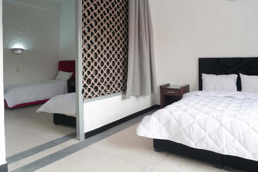 Postel nebo postele na pokoji v ubytování Hotel Warda