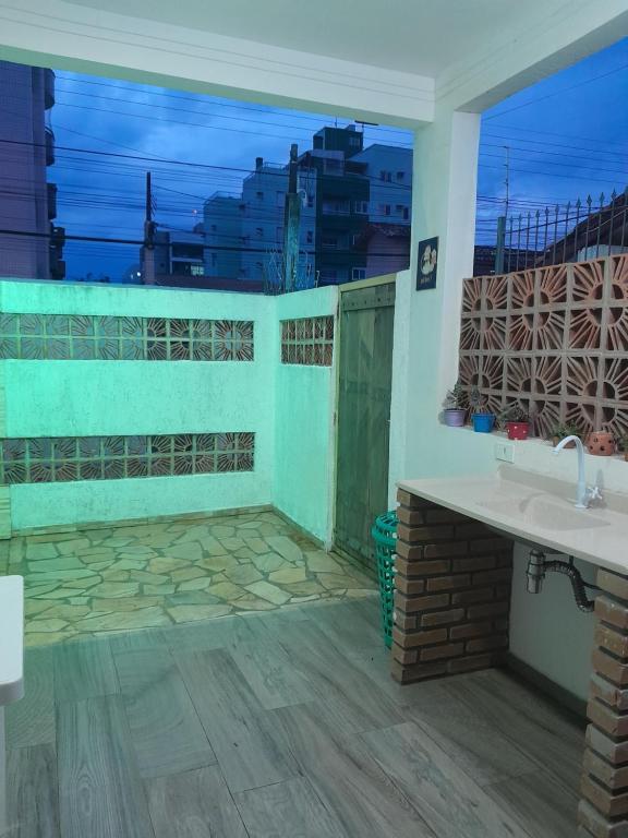 a bathroom with two sinks and a view of the city at Chalés Manacá da Serra in Ubatuba