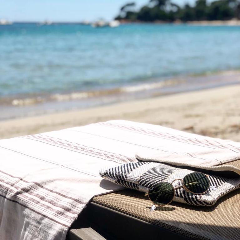 a pair of towels sitting on top of a beach at Palm Beach in Ajaccio