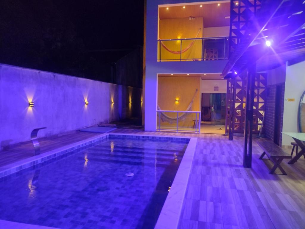a house with a swimming pool at night at Casa Barra de são Miguel in Barra de São Miguel