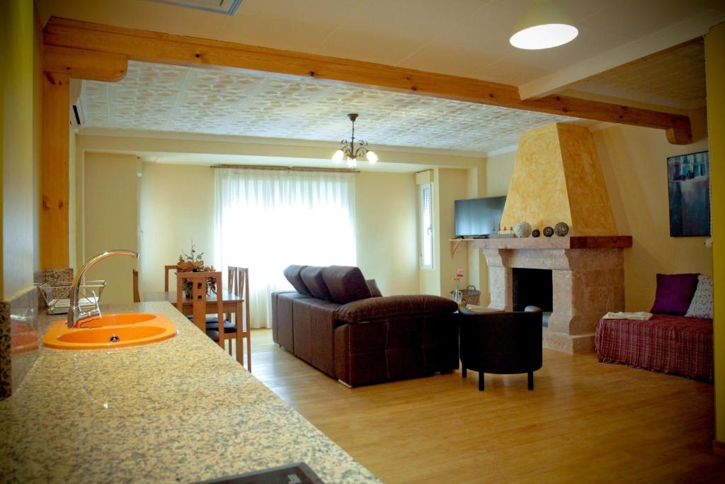 a living room with a couch and a fireplace at Casa La Remolina in Casas Ibáñez