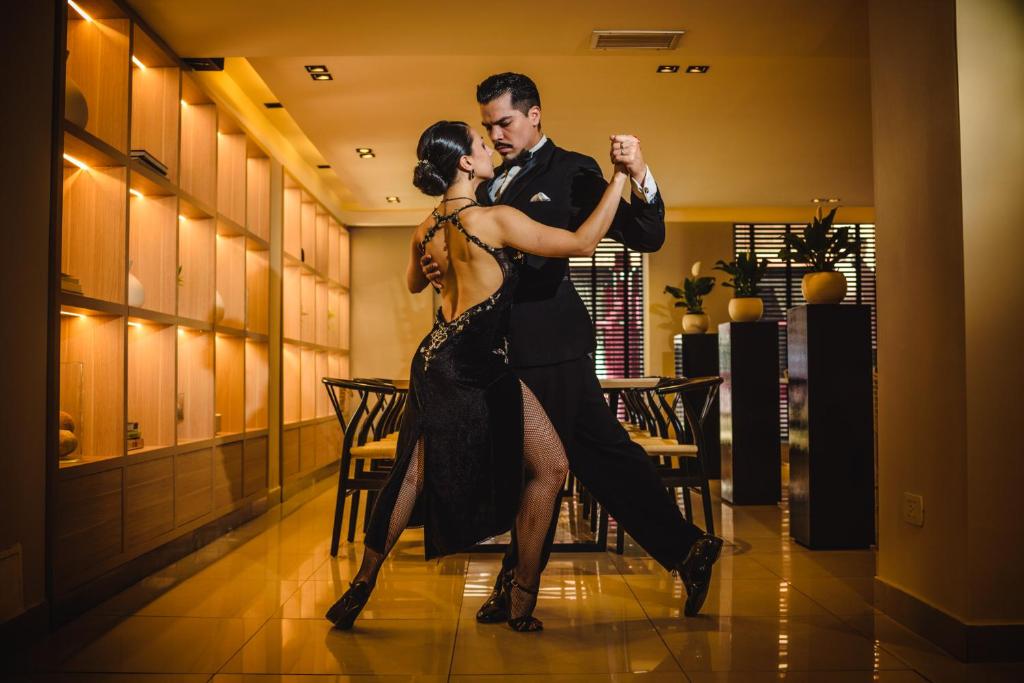 a man and a woman dancing on a dance floor at M Concept Hotel in Buenos Aires