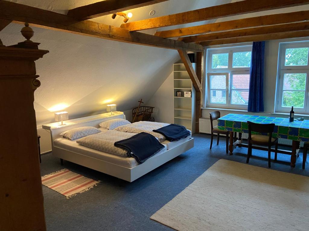 a bedroom with a large bed and a table at Stilvolles Apartment im grünen Münsterland 