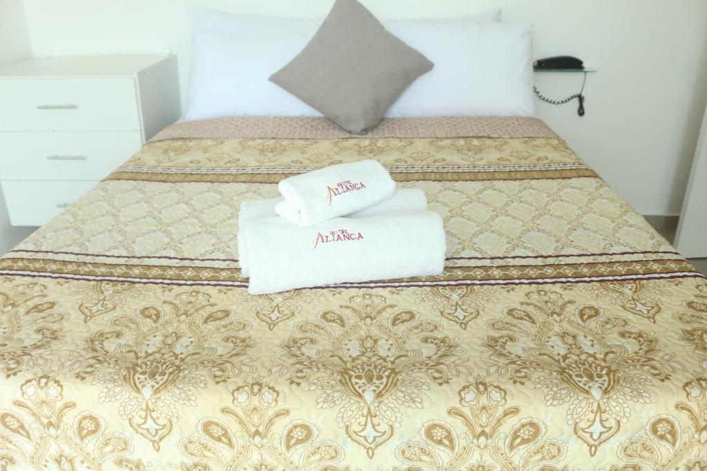 מיטה או מיטות בחדר ב-Pousada Aliança