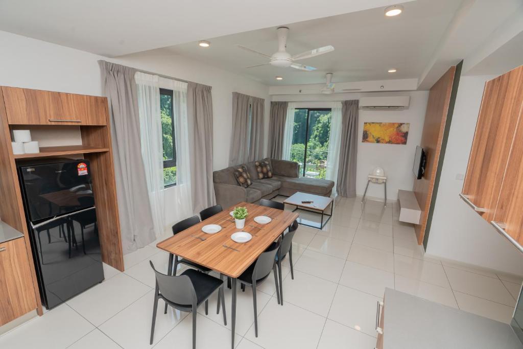 a living room with a wooden table and chairs at Ipoh Tambun Sunway Onsen Suite 3R2B Miya in Ipoh
