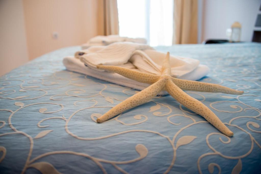 two starfish sitting on top of a bed at Apart Hotel Apolonia Palace in Sinemorets