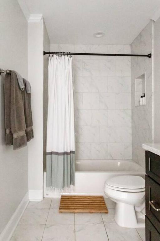 a bathroom with a tub and a toilet and a shower at Liberty Garden in Savannah