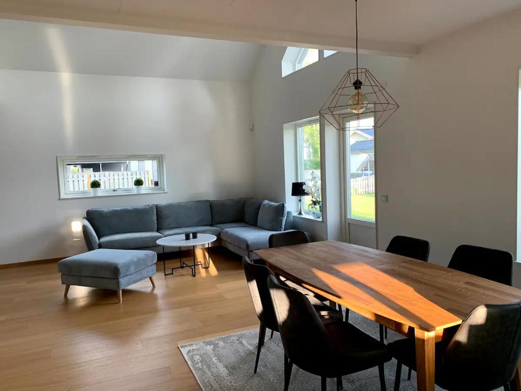 a living room with a table and a couch at Mellby Kite Surf Villa in Mellbystrand