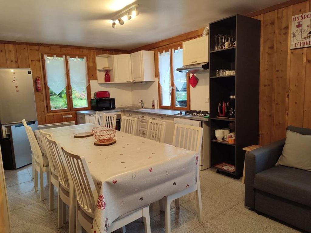 a kitchen with a table and chairs in a room at Chalet Cohennoz, 4 pièces, 10 personnes - FR-1-733-29 in Cohennoz