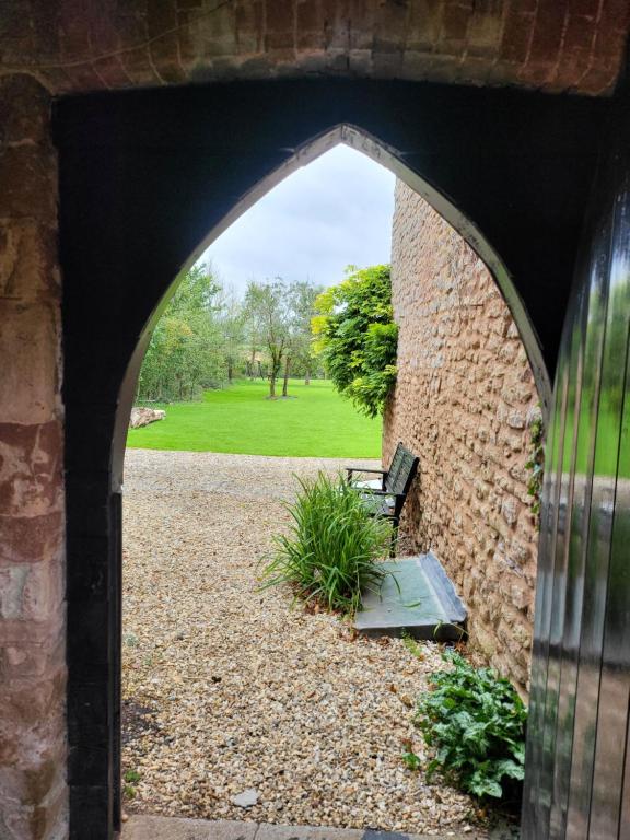 an archway with a bench sitting under a building at Beautiful One Bed Studio Flat in Bridgwater