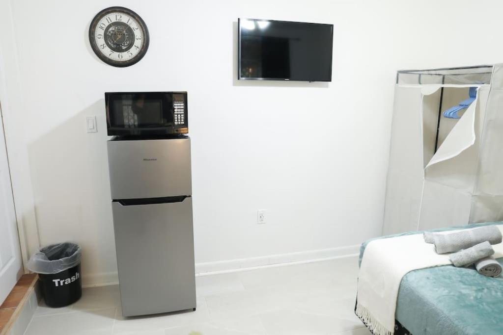 a room with a microwave on top of a refrigerator at Montu Suite Economy Room in Tampa