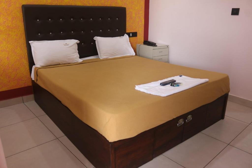 Postel nebo postele na pokoji v ubytování Hotel Wayanad Stay