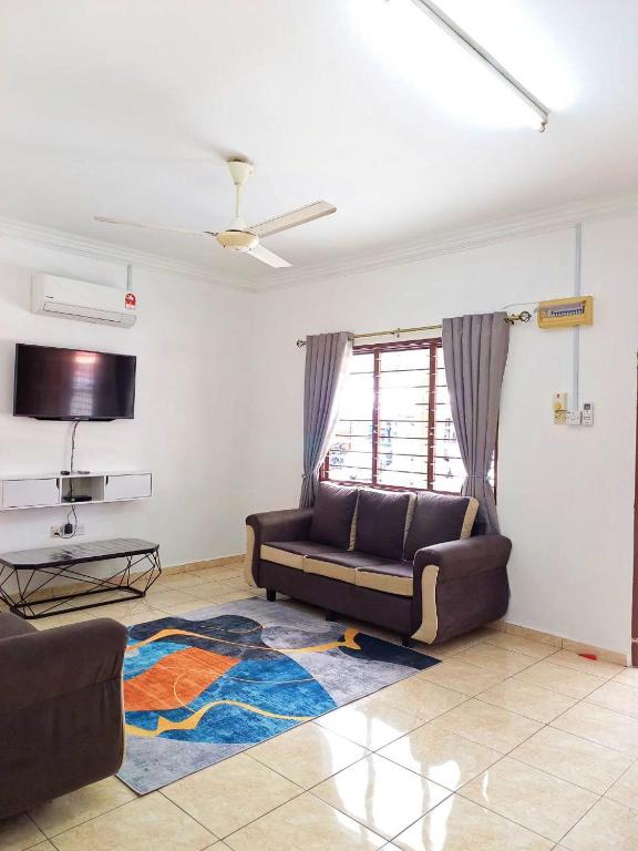 a living room with a couch and a rug at MZ homestay in Shah Alam