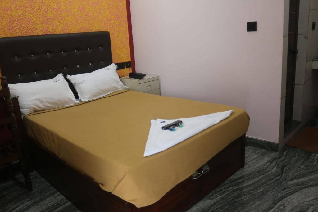 Postel nebo postele na pokoji v ubytování Hotel Wayanad Stay