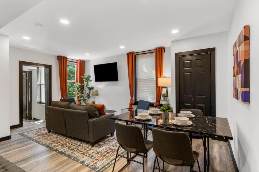 a living room with a table and a couch at Cozy 2BR,1BA Retreat for 6 with Free Parking in Philly in Philadelphia