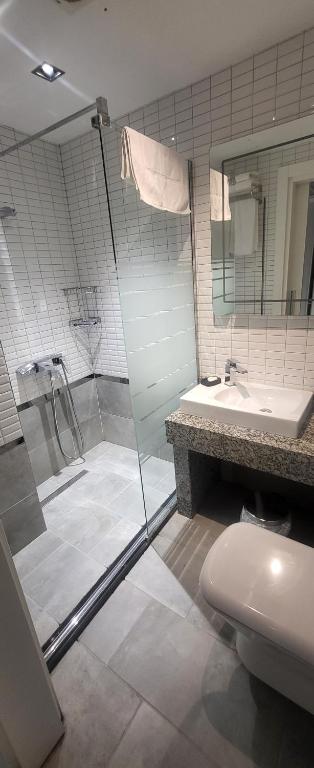 a bathroom with a shower and a toilet and a sink at MEYDAN BUTİK OTEL in Tekirdağ