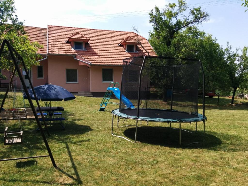 a playground with a trampoline in a yard at Chata Sovička Podhájska in Podhájska