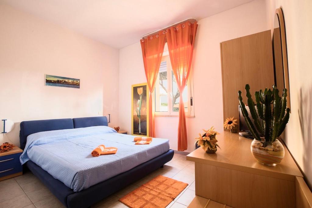 a bedroom with a blue bed and a window at ISA-Double room in hotel with swimming pool in Marina di Cecina, just 10 meters from the sea in Cecina