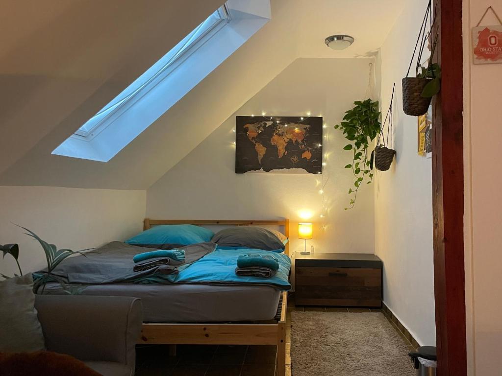 a bedroom with a bed and a skylight at Five Oaks Sky in Hamburg