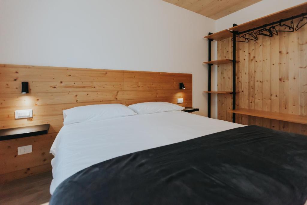 Postel nebo postele na pokoji v ubytování Falcade Lodge