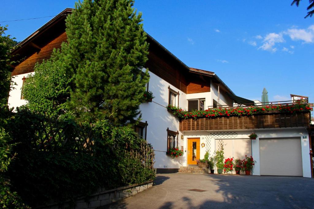 une maison blanche avec un arbre et une allée dans l'établissement Haus Kinspergher, à Innsbruck