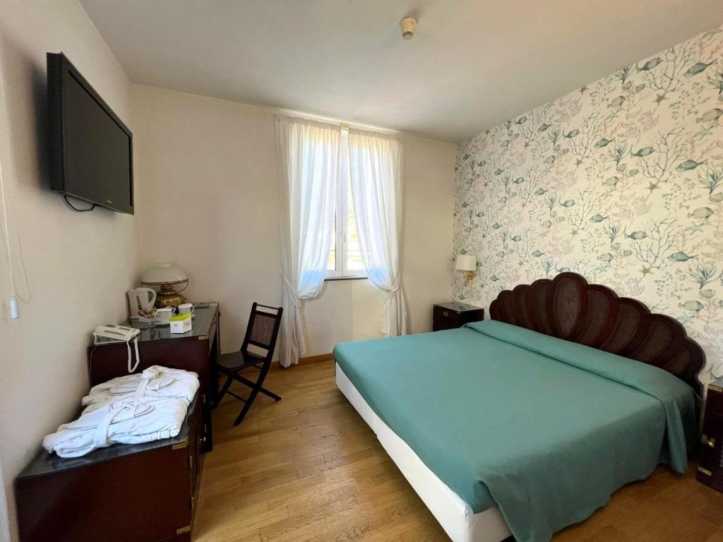 Postel nebo postele na pokoji v ubytování Hotel Clelia