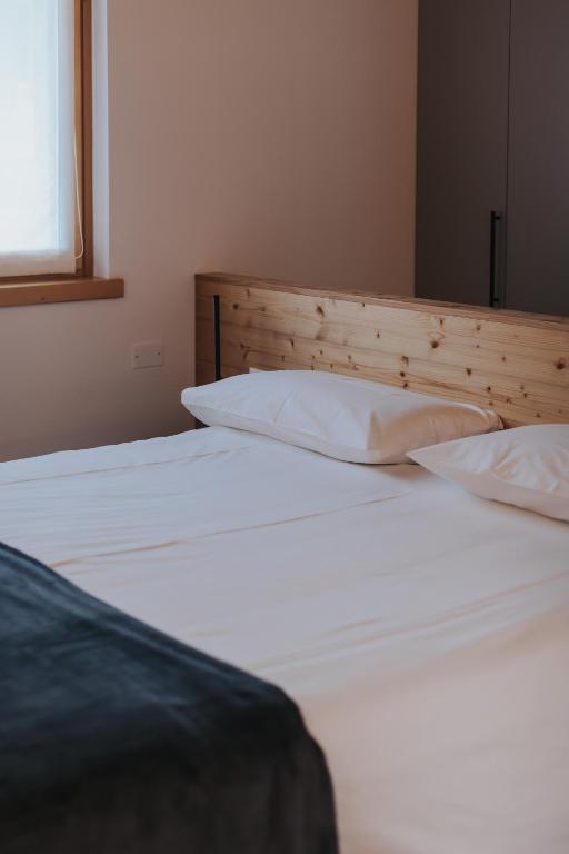 Postel nebo postele na pokoji v ubytování Falcade Lodge