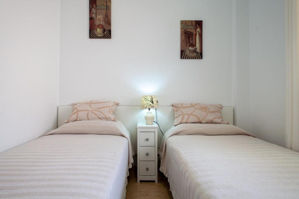 A bed or beds in a room at APARTAMENTO EL PALMERAL LOS NIETOS CERCA DE LA MANGA