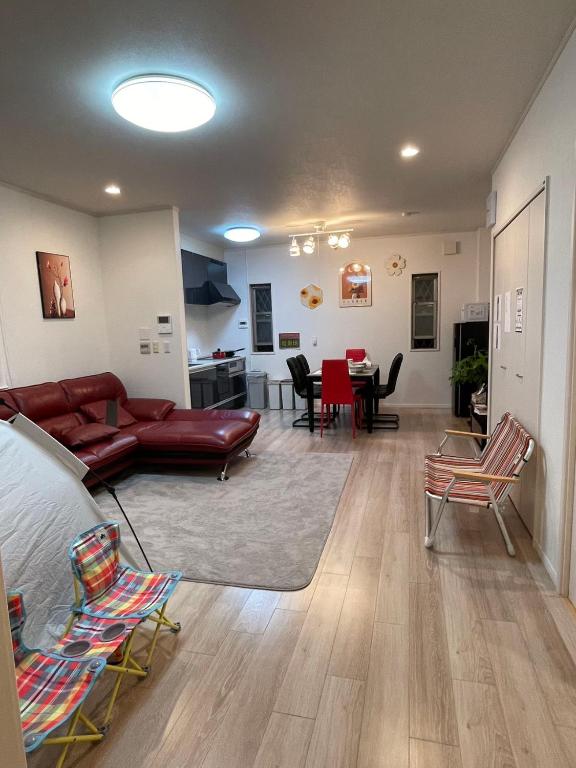 a living room with a couch and chairs and a table at 孔雀民宿 in Osaka