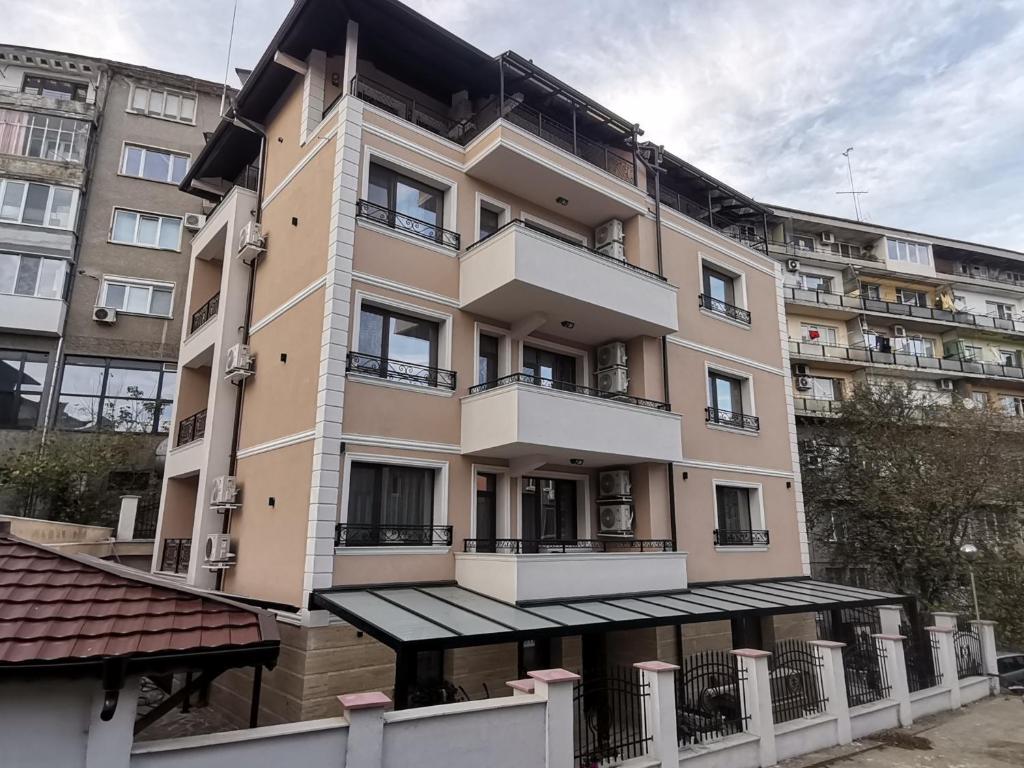 a large apartment building with a balcony in front of it at Family Boutique Residence-Free parking in Veliko Tŭrnovo