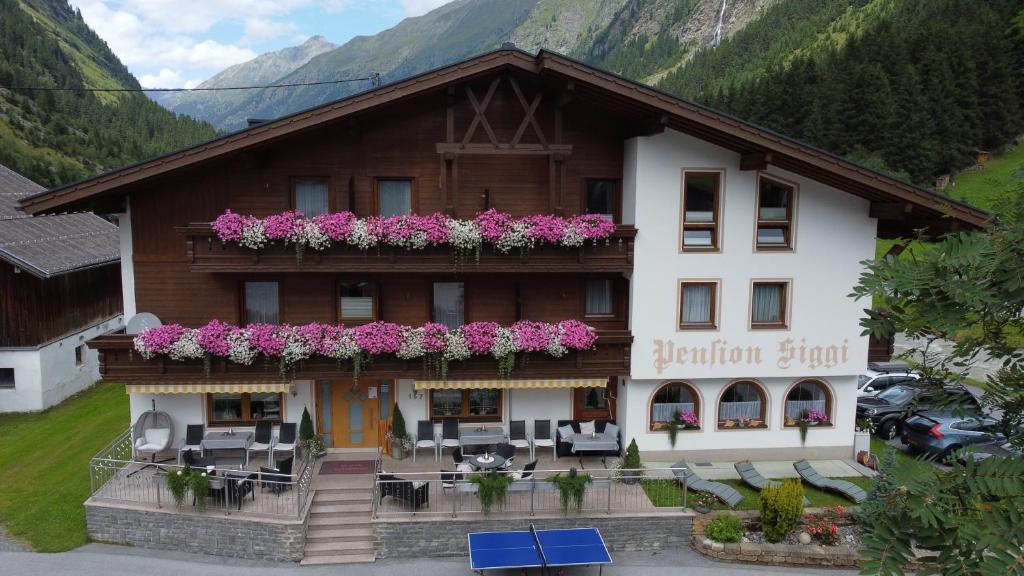 un edificio con flores en la parte delantera en Hotel Pension Siggi, en Sankt Leonhard im Pitztal