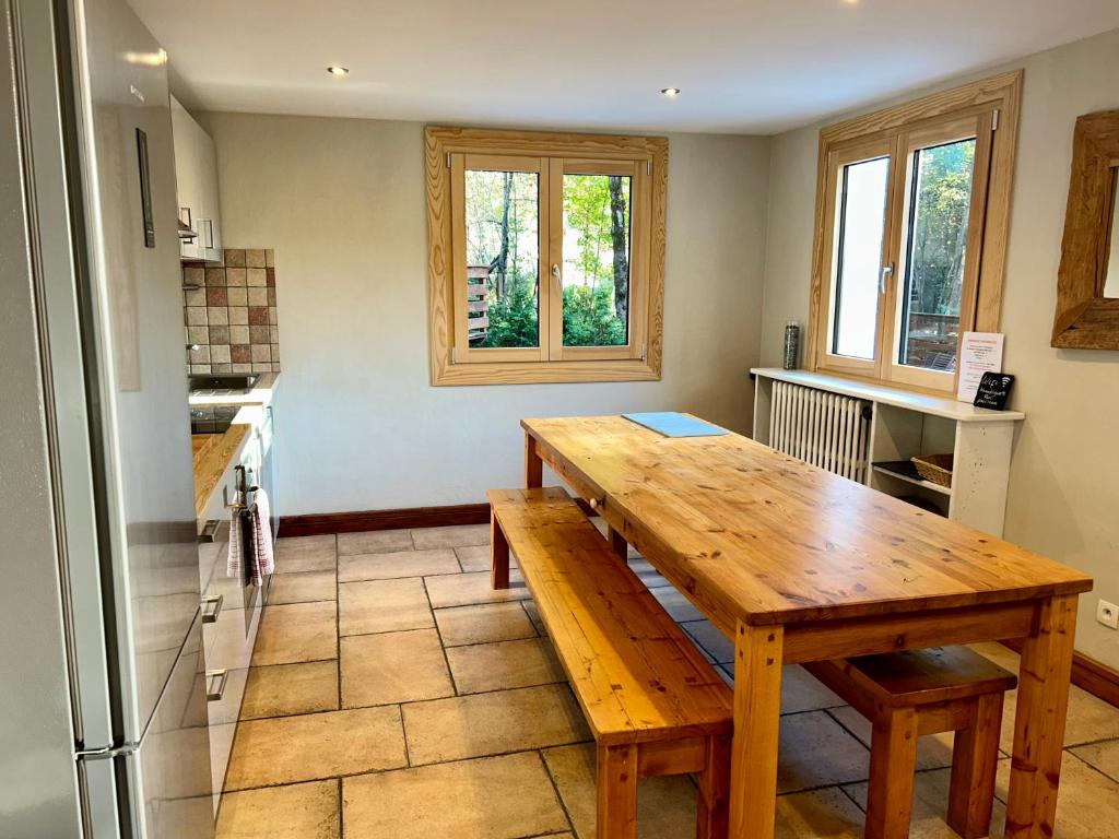 a kitchen with a wooden table and a refrigerator at The Castle, 10 Bedroom Chalet, Chamonix Centre in Chamonix