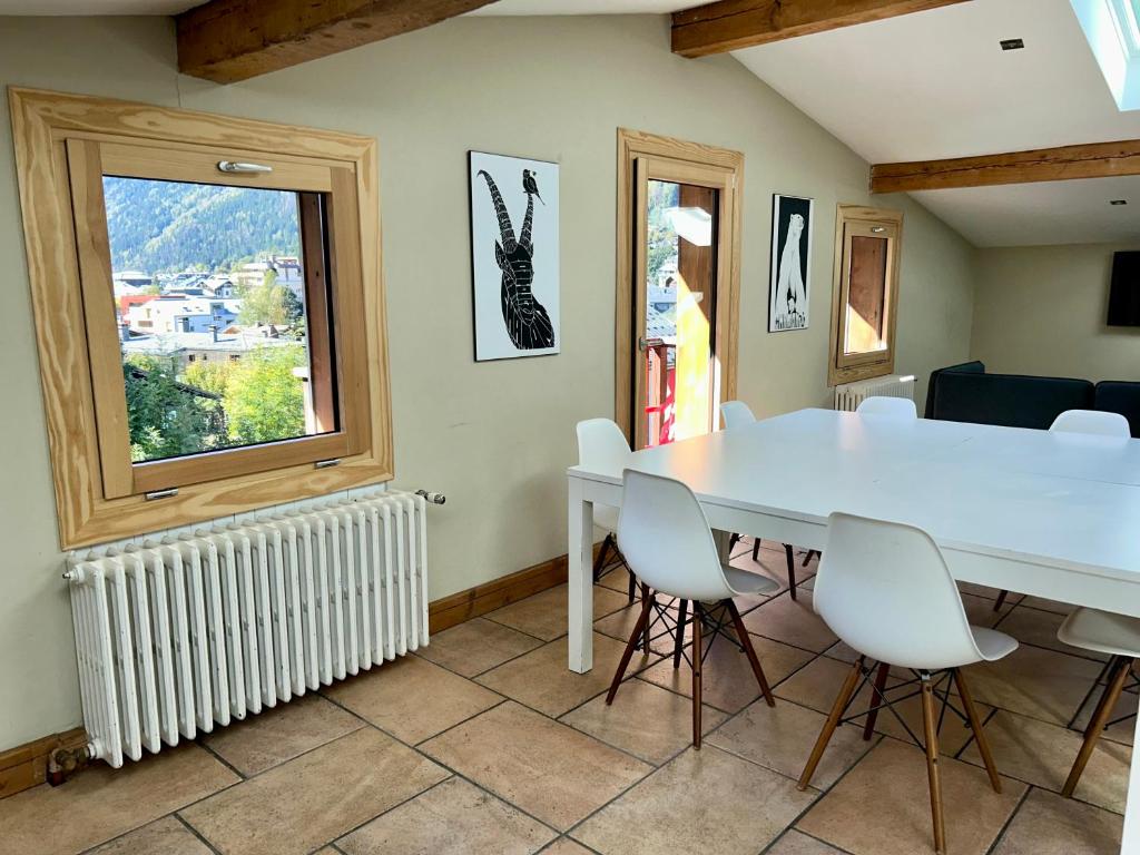 a dining room with a table and chairs and a window at The Castle, 10 Bedroom Chalet, Chamonix Centre in Chamonix
