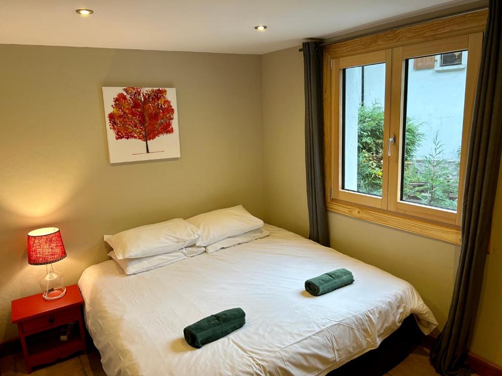 a bedroom with a bed with two pillows and a window at The Castle, 10 Bedroom Chalet, Chamonix Centre in Chamonix