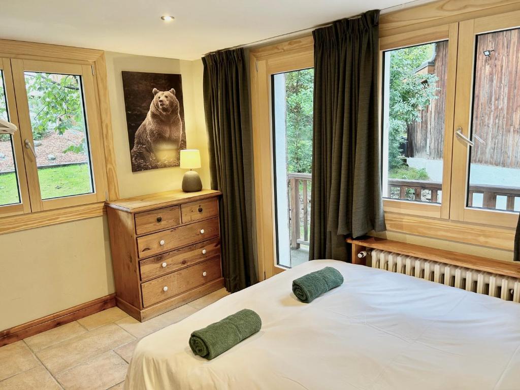 a bedroom with a bed with two green pillows on it at The Castle, 10 Bedroom Chalet, Chamonix Centre in Chamonix