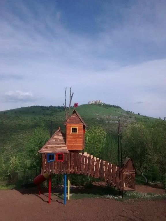 a tree house on a playground in a field at Villa Kalaja in Novoberdo
