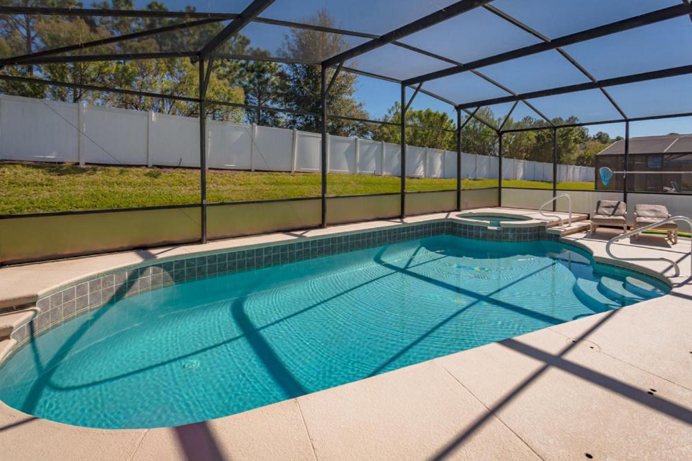 a large swimming pool with a canopy on a patio at 2217 Wyndham Palms in Kissimmee
