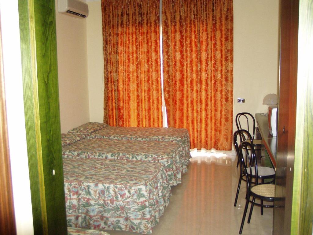 Postel nebo postele na pokoji v ubytování Hotel Le Dune