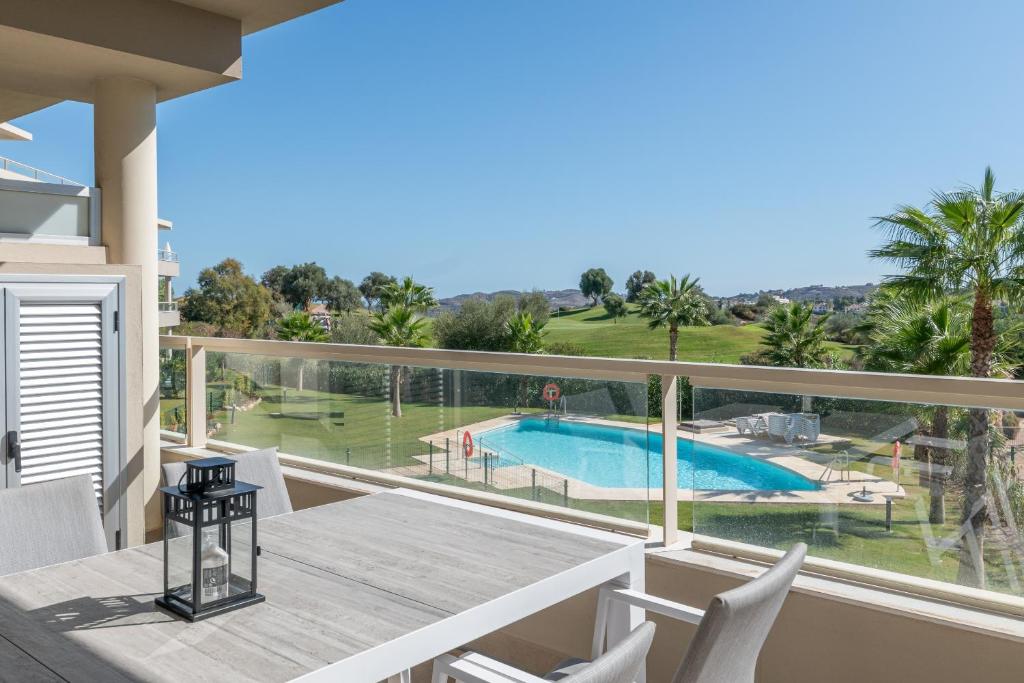 balcón con mesa y sillas y piscina en Luxury & Comfort breathtaking views - La Cala Golf en La Cala de Mijas