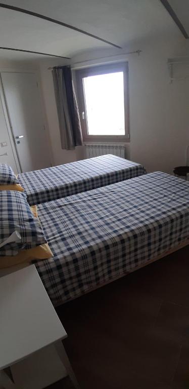 Postel nebo postele na pokoji v ubytování CASCINA BINELLO appartamento B