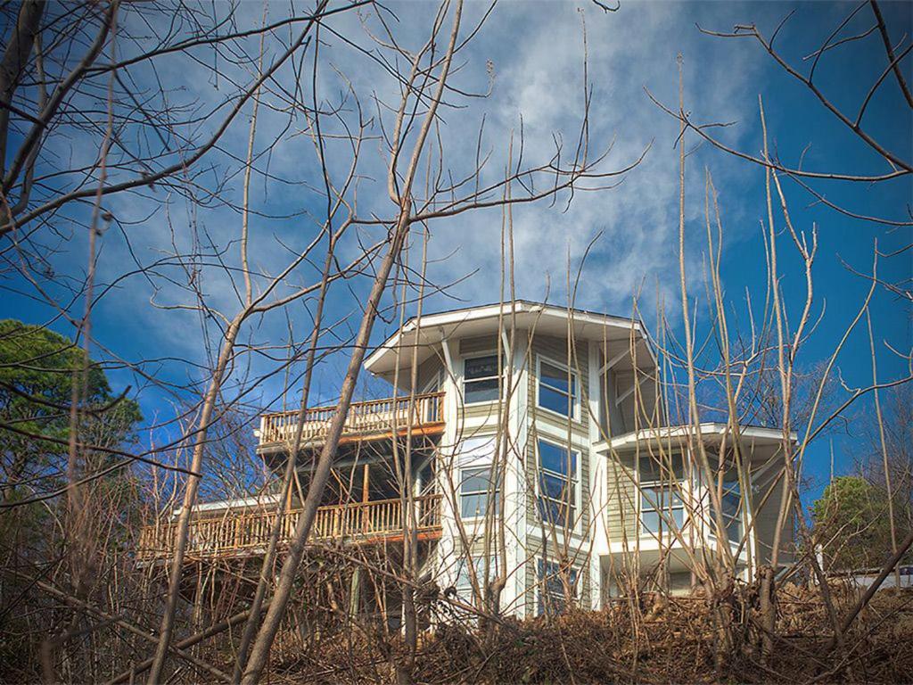 a white building with a balcony on top of it at Beautiful Mountain Views and Privacy. Minutes to downtown Gatlinburg and National Park in Gatlinburg