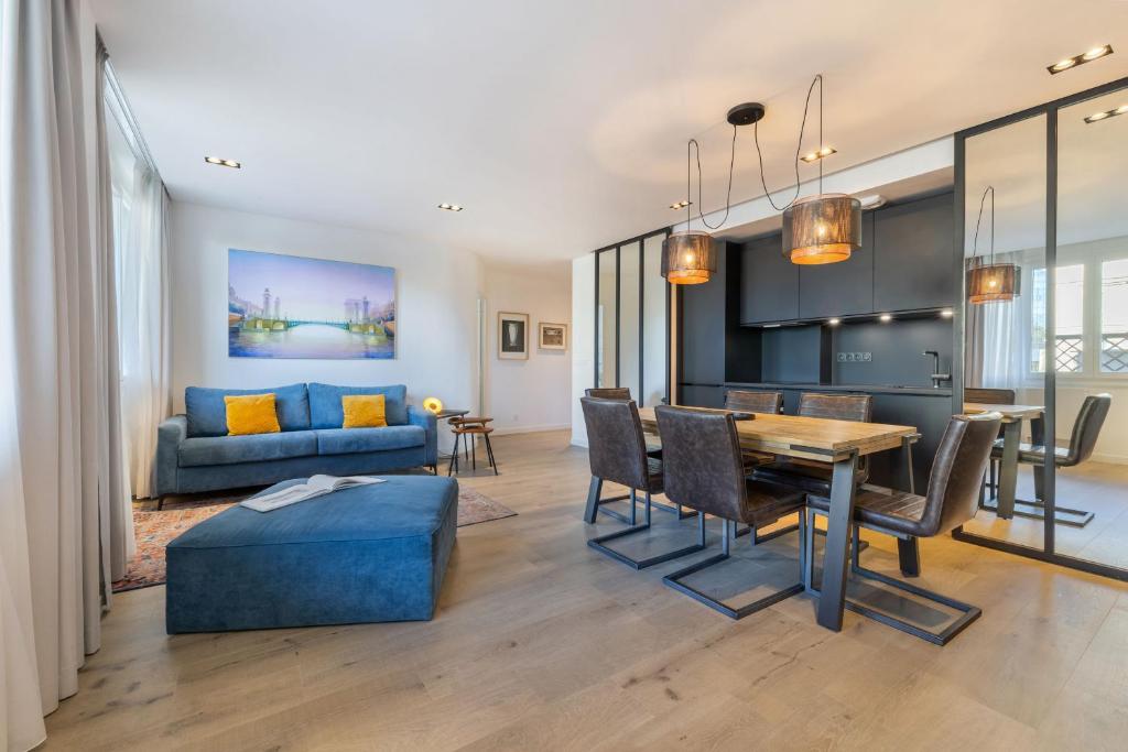a living room and dining room with a table and chairs at Atelier in Paris