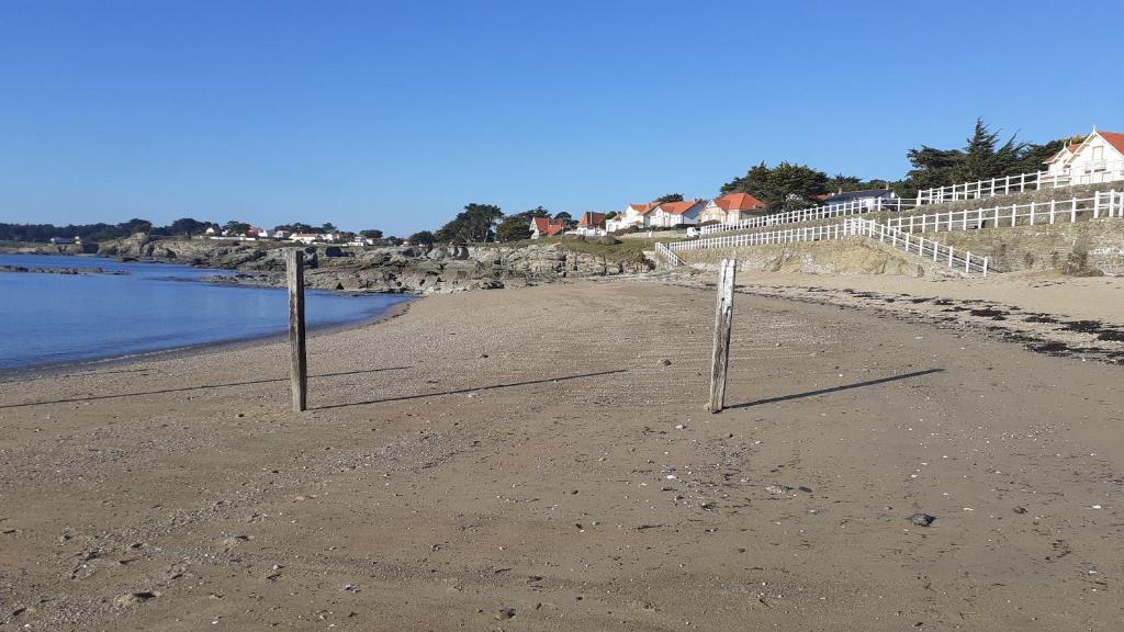 two volleyball posts on a beach near the water at Les Voiles du Clipper T2 in Préfailles