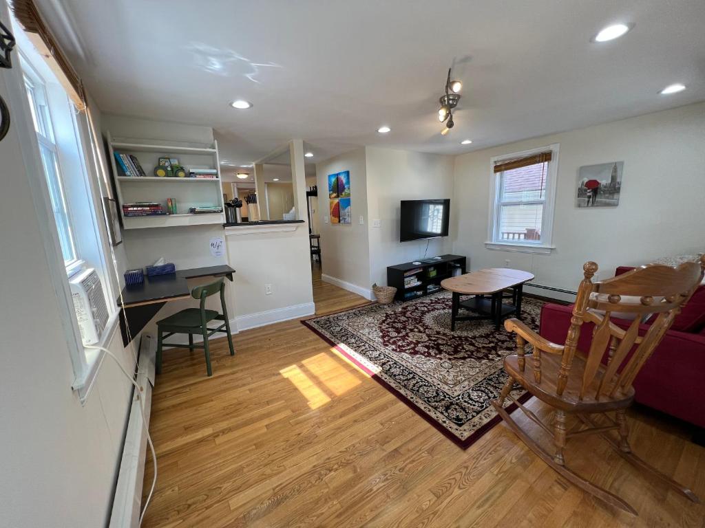 a living room with a table and chairs and a kitchen at Bright & Spacious 1 BR- King Bed & Private Yard in Providence